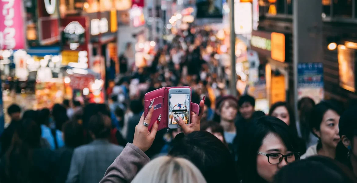 woman recording japanese crowd