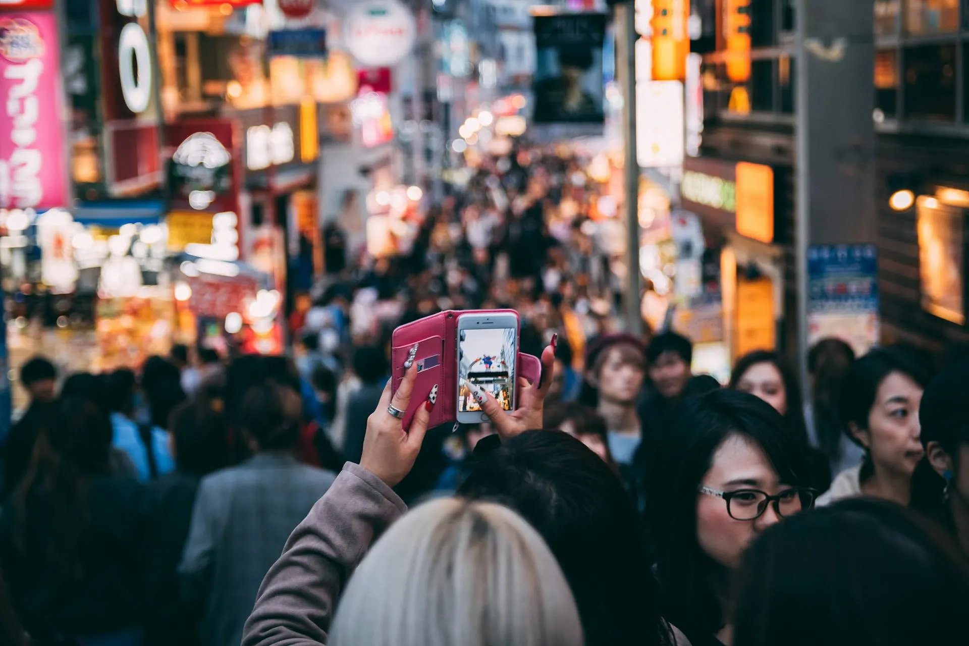 woman recording japanese crowd